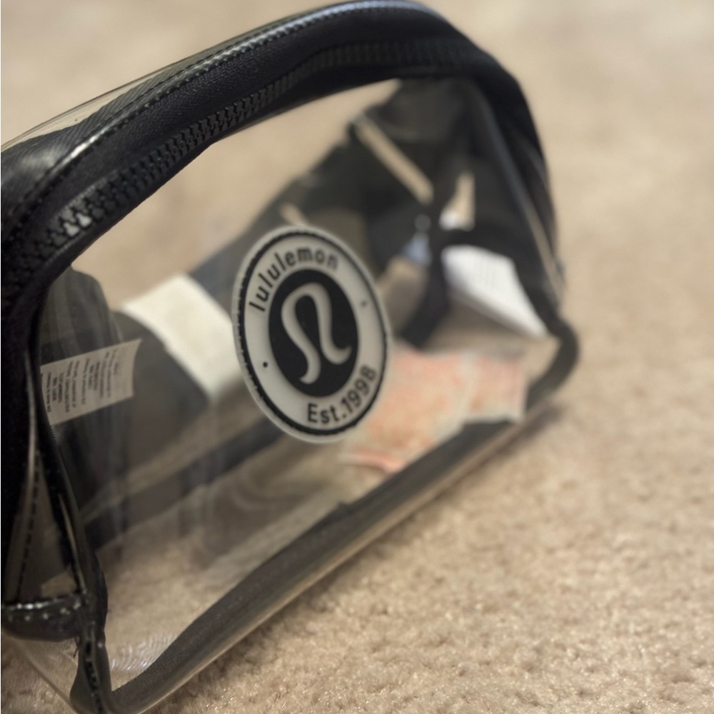 Lululemon Everywhere Belt Bag Clear plastic material with black trim.